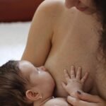 a mother breast-feeding her baby